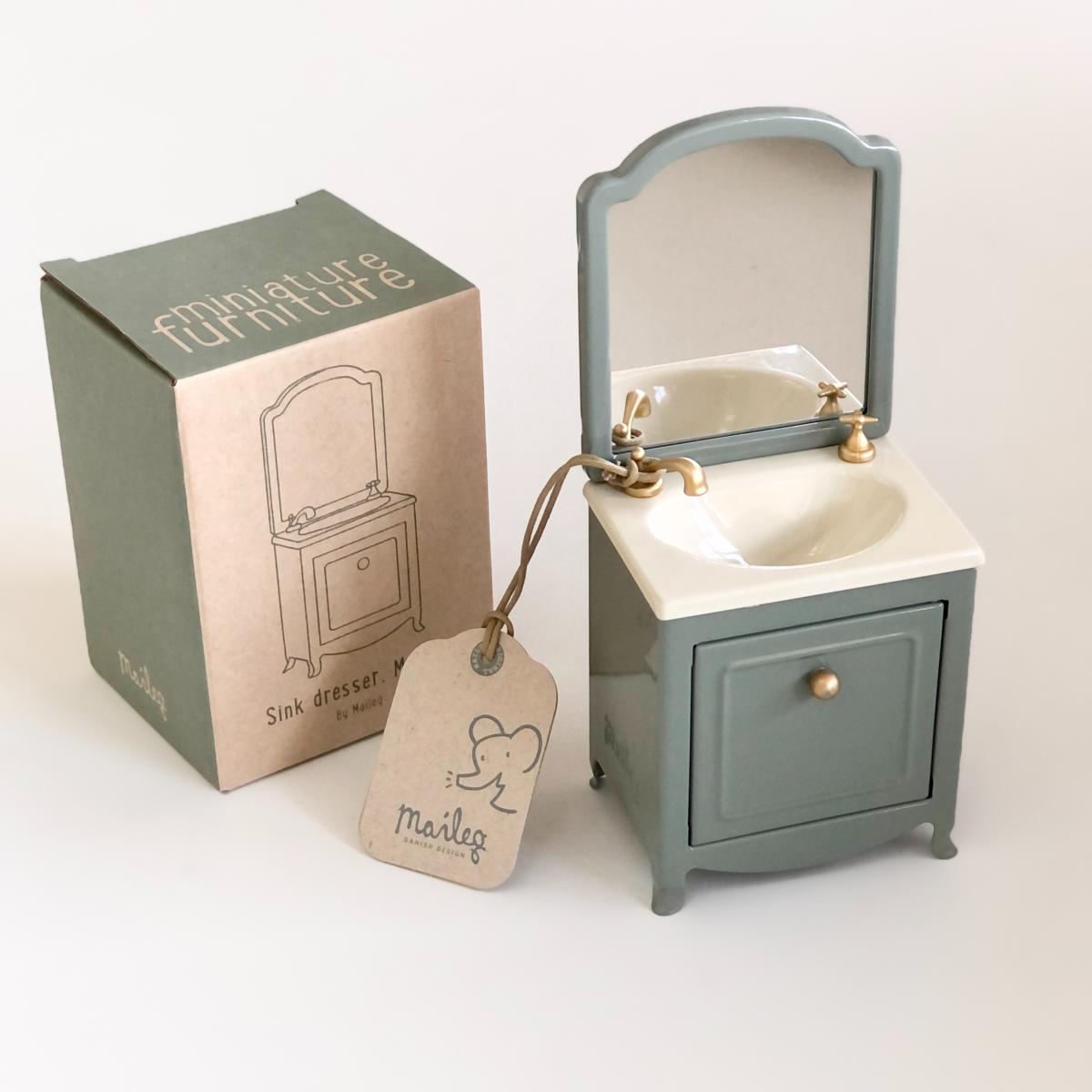 a miniature sink and a box on a white background
