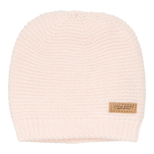 a white knitted hat with a tag on the front
