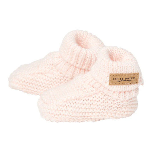 a pair of pink knitted slippers on a white background