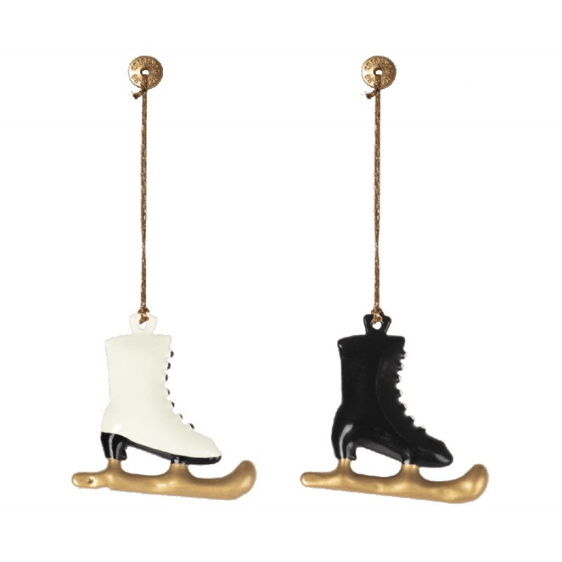 a pair of ice skates hanging from a rope
