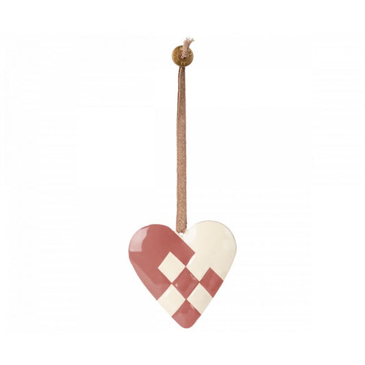 a red and white heart hanging from a rope