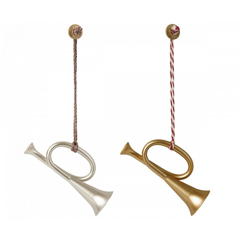 two brass and silver musical instruments hanging from strings