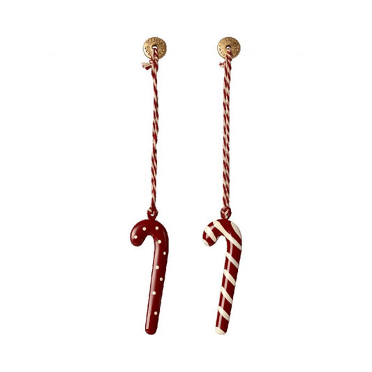 a pair of candy canes hanging from a string
