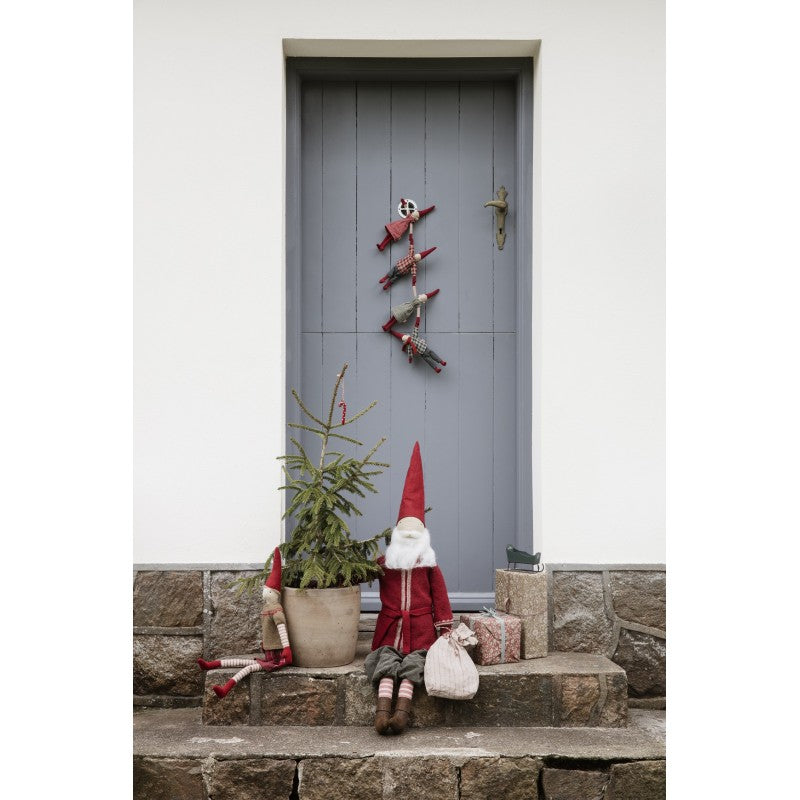 a gnome sitting on a step next to a door